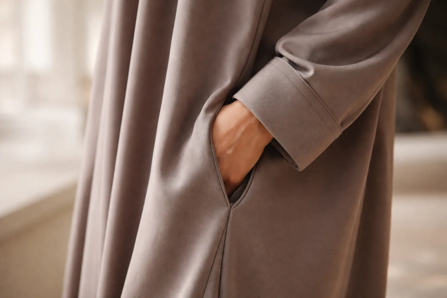 close view of soft abaya fabric and cuffed sleeve with hidden pocket